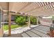 Covered backyard patio with brick walls and partial garden area, great for entertaining at 2753 Port Of Call Dr, Las Vegas, NV 89128