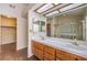 Bathroom with double sinks, wood cabinets, and tile countertops at 2753 Port Of Call Dr, Las Vegas, NV 89128