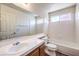 Bright bathroom features a large mirror, white tiled shower-tub, and a single sink vanity at 2753 Port Of Call Dr, Las Vegas, NV 89128