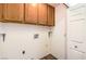 Functional laundry area with overhead cabinets and tile flooring at 2753 Port Of Call Dr, Las Vegas, NV 89128