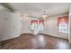 Open living room featuring wood-look tile floors and lots of natural light at 2753 Port Of Call Dr, Las Vegas, NV 89128