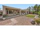 Well-maintained backyard with a covered patio, desert landscaping, and a walkway to a grassy area at 2810 Somerset Springs Dr, Henderson, NV 89052