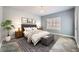 A beautifully staged bedroom featuring a tufted headboard, plantation shutters, and tile flooring at 2810 Somerset Springs Dr, Henderson, NV 89052
