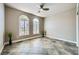 A serene room with dual arched windows, plantation shutters, and tile flooring at 2810 Somerset Springs Dr, Henderson, NV 89052