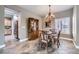 Dining room with a chandelier, dining table and hutch, situated adjacent to the kitchen at 2810 Somerset Springs Dr, Henderson, NV 89052