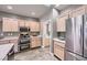 Well-lit kitchen with stainless steel appliances, double oven, and ample cabinet space at 2810 Somerset Springs Dr, Henderson, NV 89052