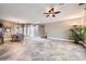 Spacious living room featuring tile flooring, a ceiling fan, and natural light from windows and skylights at 2810 Somerset Springs Dr, Henderson, NV 89052