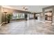 Spacious open-plan living area with natural light, tile flooring, and seamless flow into the kitchen at 2810 Somerset Springs Dr, Henderson, NV 89052