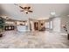 Open-concept living room featuring tile floors, neutral colors, a ceiling fan, and natural light at 2810 Somerset Springs Dr, Henderson, NV 89052
