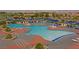 Resort-style outdoor pool with lounge chairs, tables, and umbrellas perfect for relaxing and enjoying the community at 2810 Somerset Springs Dr, Henderson, NV 89052