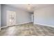 A spacious room with tile flooring, a modern chandelier, and a door with access to the outdoors at 2810 Somerset Springs Dr, Henderson, NV 89052