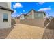 Easy-care backyard with a gravel landscape, partial brick patio, and a block wall creating a private outdoor space at 3192 Timorasso Ave, Henderson, NV 89044
