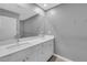 Bathroom featuring double sinks with white countertops and a large mirror at 3192 Timorasso Ave, Henderson, NV 89044
