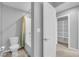 Bathroom with toilet, tiled bathtub/shower, and a walk-in closet with shelves at 3192 Timorasso Ave, Henderson, NV 89044