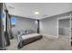Cozy bedroom with soft carpet, neutral gray walls, and ample natural light from multiple windows at 3192 Timorasso Ave, Henderson, NV 89044