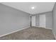 Empty bedroom with carpeted floor and two white doors with neutral color palette at 3192 Timorasso Ave, Henderson, NV 89044