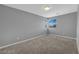 Empty bedroom with carpeted floor and window with neutral color palette at 3192 Timorasso Ave, Henderson, NV 89044
