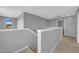 Bright hallway with neutral walls, carpet, and a view from the window, creating a clean and modern space at 3192 Timorasso Ave, Henderson, NV 89044