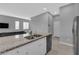 Modern island kitchen with sleek stainless steel appliances and granite countertop at 3192 Timorasso Ave, Henderson, NV 89044