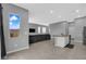 Open-concept living area with sleek gray sofa and modern kitchen view at 3192 Timorasso Ave, Henderson, NV 89044