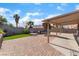 Enjoy outdoor dining and relaxing in this backyard with covered patio, palm trees and built-in barbecue at 3443 Citruscedar Way, North Las Vegas, NV 89032