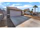 View of large driveway leading to a two-car garage with desert landscaping at 3443 Citruscedar Way, North Las Vegas, NV 89032
