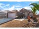 Charming single-story home featuring desert landscaping, with a two-car garage and covered entry at 3443 Citruscedar Way, North Las Vegas, NV 89032
