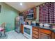Kitchen featuring stainless steel appliances, dark wood cabinets, and granite countertops in the cooking area at 3443 Citruscedar Way, North Las Vegas, NV 89032
