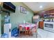 The kitchen has stainless steel appliances and a dining table with seating for four beneath overhead lighting at 3443 Citruscedar Way, North Las Vegas, NV 89032