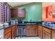 Kitchen view highlighting dark cabinets, granite countertops, and a stainless steel sink beneath the window at 3443 Citruscedar Way, North Las Vegas, NV 89032