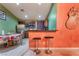 The kitchen features unique two-tone walls, stainless appliances, and a breakfast bar with two stools at 3443 Citruscedar Way, North Las Vegas, NV 89032