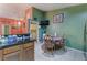 View of the kitchen with stainless steel refrigerator, dining table, and a laundry room in the background at 3443 Citruscedar Way, North Las Vegas, NV 89032
