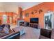 Spacious living room featuring tile floors, a cozy fireplace, and an entertainment center at 3443 Citruscedar Way, North Las Vegas, NV 89032