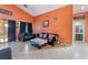 Open-concept living room featuring tile floors, high ceilings, and sliding glass doors to the outdoor patio at 3443 Citruscedar Way, North Las Vegas, NV 89032