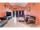 Cozy living room features tile flooring, comfortable seating, and a view of the outdoors at 3443 Citruscedar Way, North Las Vegas, NV 89032