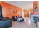 Open-concept living room featuring tile floors, a fireplace, and easy access to the kitchen and dining area at 3443 Citruscedar Way, North Las Vegas, NV 89032