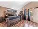 The main bedroom has hardwood floors, and a large bed with a neutral color scheme, and modern furnishings at 3443 Citruscedar Way, North Las Vegas, NV 89032