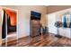 View of the main bedroom showing hardwood floors, large dresser, ceiling fan, and a doorway to the bathroom at 3443 Citruscedar Way, North Las Vegas, NV 89032