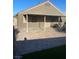 View of covered patio with brick pavers, privacy door, and outdoor grill at 3443 Citruscedar Way, North Las Vegas, NV 89032