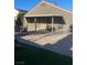 View of covered patio with brick pavers, patio furniture, and green grass at 3443 Citruscedar Way, North Las Vegas, NV 89032
