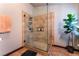 Walk-in shower features custom tile design, a glass surround, and built-in storage at 3443 Citruscedar Way, North Las Vegas, NV 89032