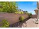 Private backyard featuring a brick-paved patio and green landscaping at 3709 Neblina Dr, Henderson, NV 89052