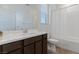 Bathroom featuring a bathtub/shower combo, a modern dark wood vanity, and a large mirror at 3709 Neblina Dr, Henderson, NV 89052