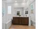 Bathroom featuring a soaking tub, glass-enclosed shower, and double sink vanity at 3709 Neblina Dr, Henderson, NV 89052
