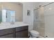 Modern bathroom with a sleek vanity, a framed mirror, and a glass-enclosed shower at 3709 Neblina Dr, Henderson, NV 89052