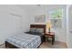 Comfortable bedroom featuring a wood-framed bed, wood bedside table, and window at 3709 Neblina Dr, Henderson, NV 89052