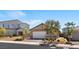 Charming single-story home featuring a brick driveway, a two-car garage, neutral paint, and mature landscaping at 3709 Neblina Dr, Henderson, NV 89052