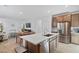 Bright kitchen featuring stainless steel appliances, a center island, and an adjacent dining area at 3709 Neblina Dr, Henderson, NV 89052
