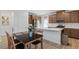 Modern kitchen and dining area featuring wood cabinets, stainless steel appliances, and an island with seating at 3709 Neblina Dr, Henderson, NV 89052