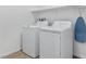 Laundry room with a front-load washing machine, dryer, and storage shelf at 3709 Neblina Dr, Henderson, NV 89052
